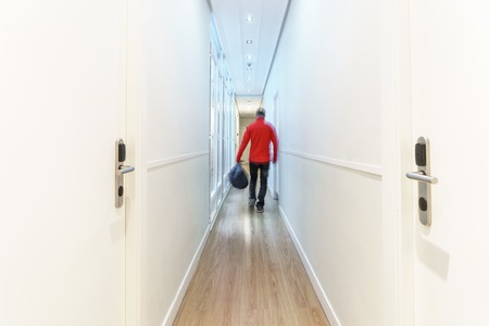 Blurred tourist arriving to hotel along corridor, long exposureの写真素材