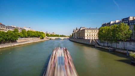 Blurred tourist boat over Seine river, Parisの写真素材