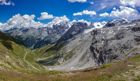 Stelvio ascent, prato side, snow over mountainsの写真素材