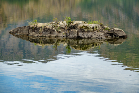 Tiny rock in the middle of a lakeの写真素材