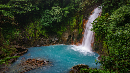 Celestial blue waterfall and pond in volcan tenorio national parkの写真素材