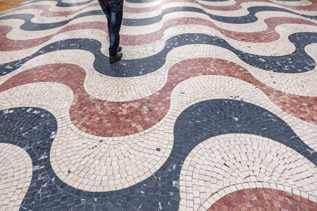 Popular street maritime promenade with man legs in Alicante