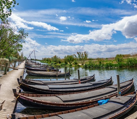 Albufera nature reserve with wooden fishing boats and pier in Catarroja, Valenciaの写真素材
