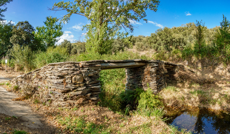 Old antique stone bridge over streamの写真素材