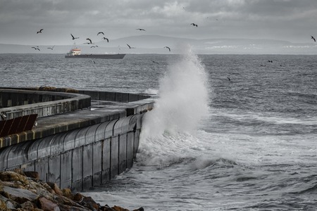 Waves breaking over breakwater