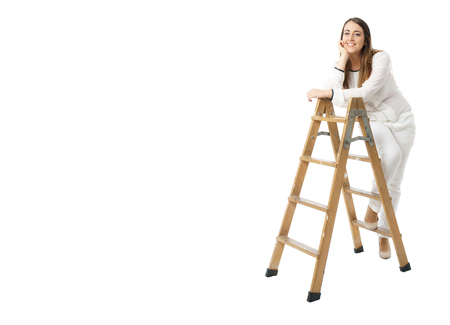 Woman with glasses and wooden ladder on whiteの写真素材