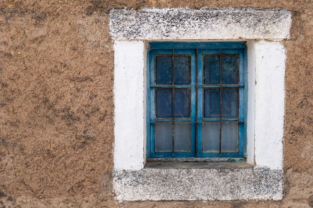 Old blue wooden window frame with grilleの写真素材