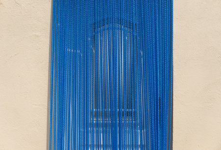 Blue rubber curtain at residential home entranceの写真素材