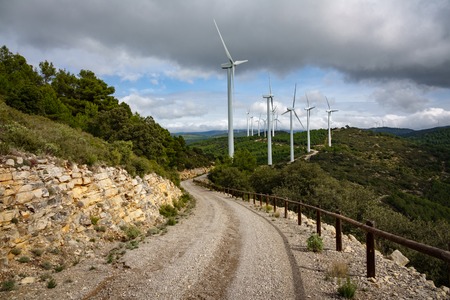 Windmill farm in the mountain, cloudy dayの写真素材