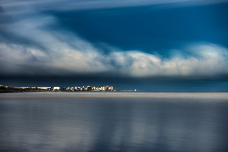 Ultra long exposure of skyscrappers and sea with cloudsの写真素材