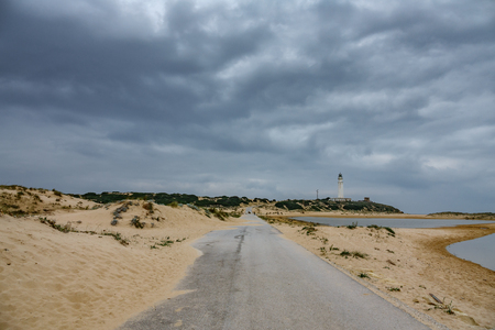 Road to Trafalgar lighthouse under stormy skyの写真素材