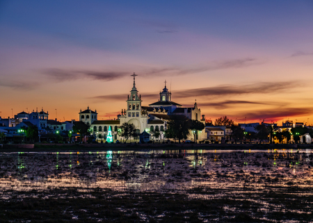 El Rocio village at sunset with pink sky and lakeの写真素材