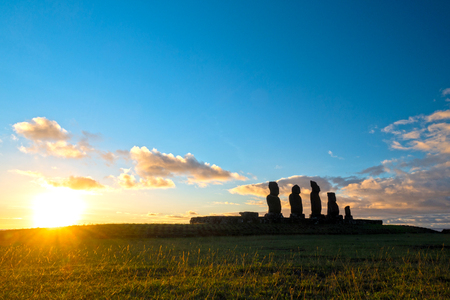 Long exposure of Moais in Ahu Tahai at sunset with sun in the horizonの写真素材