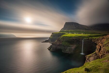 Wide angle view of Gasadalur waterfall long exposure in Faroe Islands, Vagar islandの写真素材