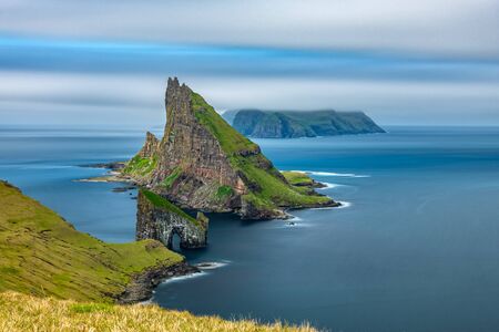 Amazing top view long exposure of Drangarnir gate in front of Tindholmur, Faroe Islandsの写真素材