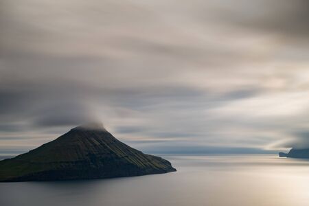 Ultra long exposure of islet in Faroe Islands at sunsetの写真素材