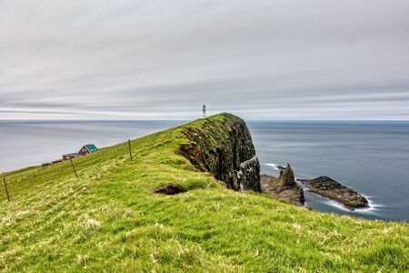 Mykines island lighthouse long exposure in Faroe islandsの写真素材