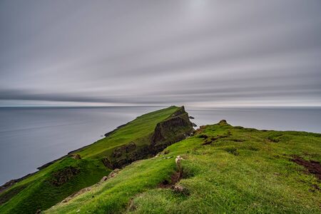 Mykines island lighthouse long exposure wide angle in Faroe islandsの写真素材