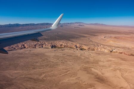 Jet wing over the dry atacama desertの写真素材