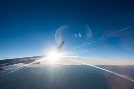 Light beams in jet airplane wing flyingの写真素材
