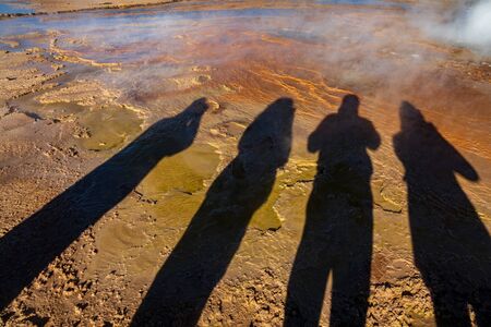 Tourist shadows near geyser with bright colorsの写真素材