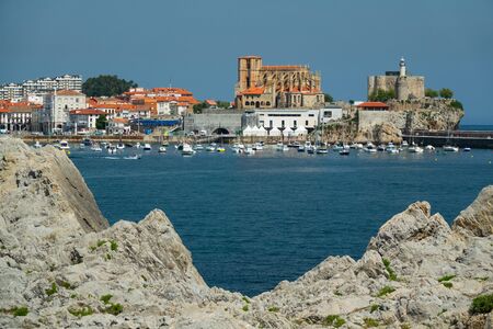 Castro Urdiales downtown and cathedral framed with rocksの写真素材