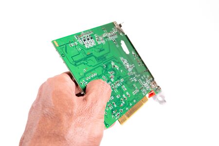 Left hand giving circuit board against white background closeupの写真素材