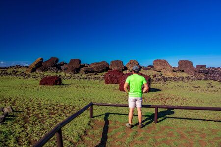 Rear view of unrecognizable tourist looking Moaisの写真素材