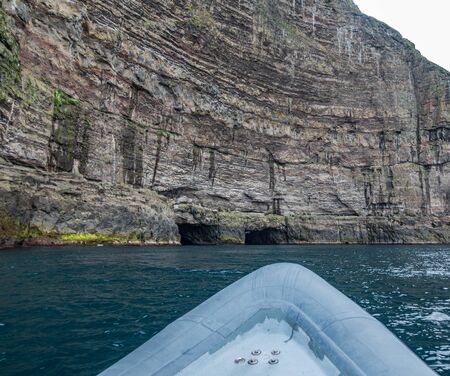 Motorboat approaching to two tunnels in the wallの写真素材