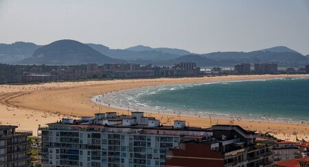 Beach in the middle of the city crowded with housesの写真素材