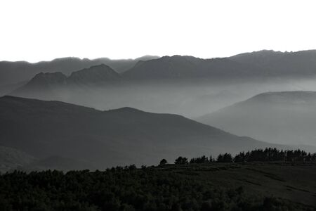 Mist over the mountains, white sky for textの写真素材