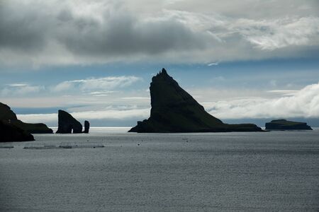 High contrast of Drangarnir gate and Tindholmur, Faroe Islandsの写真素材