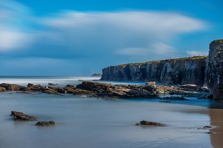 Long exposure in cathedral beach with rock holesの写真素材
