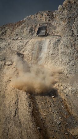 Dumper unloading stones from mine to dumpの写真素材