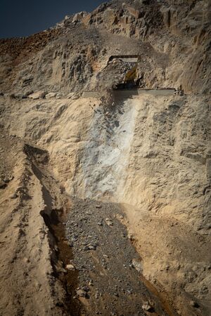 Dumper unload debris from mine to dumpの写真素材