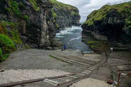 Gjogv gorge with tourist on the island of Eysturoy in the Faroe Islands.の写真素材