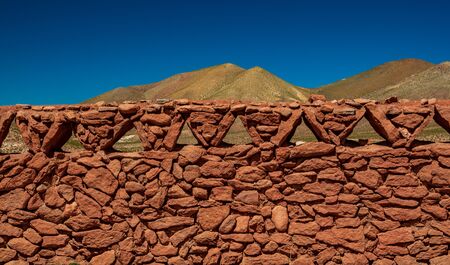 Antique vintage stone fence under clear blue skyの写真素材