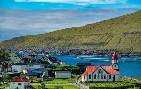 Lutheran Church With Red Roof and Sandavagur villageの写真素材
