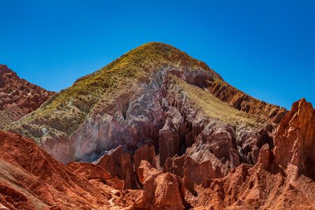 Red and green sand under clear blue skyの写真素材