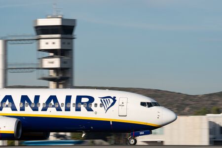 Ryanair plane landing panning with control tower in the backgroundのeditorial素材