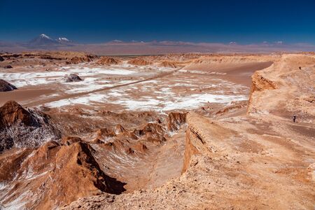 Moon valley with track, tourists and Licancabur volcanoの写真素材