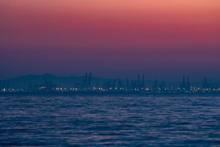 Huge cranes in the port at dusk, long shotの写真素材