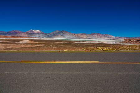 Road near red stones salt lake in Atacamaの写真素材
