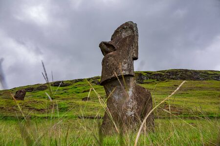 Bottom view of single moai under cloudy skyの写真素材