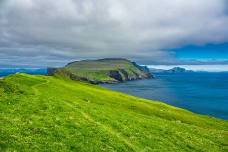 Mykines island and ocean in Faroe Islandsの写真素材