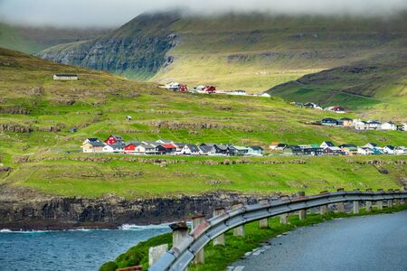 Faroe Islands typical village near the ocean with roadの写真素材