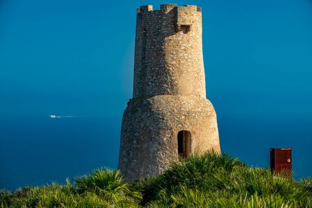 Gerro tower in Denia with ferry in the backgroundの写真素材