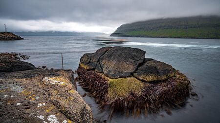 Two massive boulders moving back and forth with the sea force, long exposureの写真素材