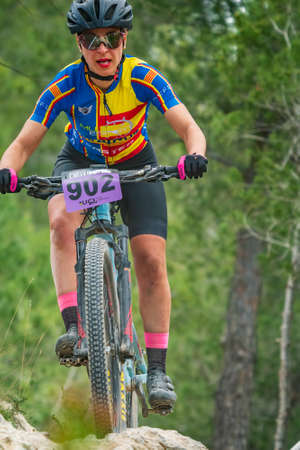 Gloria Medina descending the pine tree forest during in MTB championshipのeditorial素材