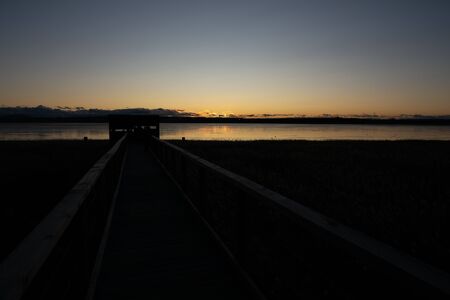 Sunset with lake, cab and track with clear skyの写真素材